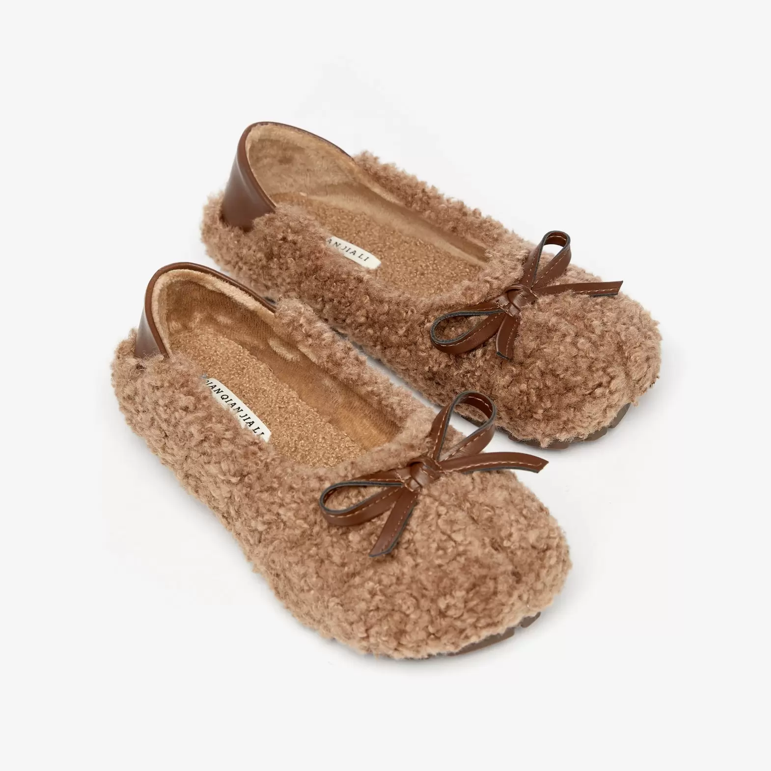Homemade slippers made of artificial plush with beige bows